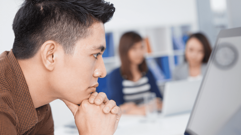 Man intently looking at the computer screen waiting for a reply